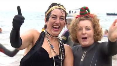 Swimmers in fancy dress at Abersoch beach