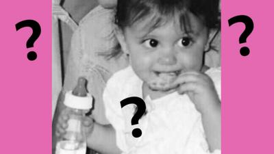 Baby picture with question marks.