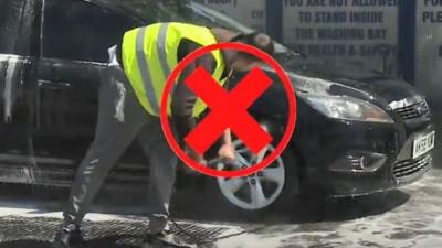 man cleaning car