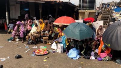 People sitting in the floor in Okobaba