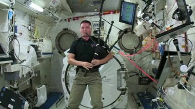 America astronaut playing bagpipes in space.