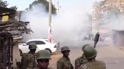 Police officers fire teargas