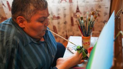 The nuclear campaigner and artist, Karipbek Kuyukov, painting with his mouth.