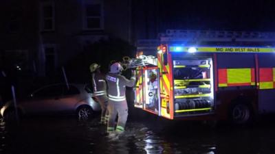 Firefighters in flood water