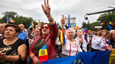 People protest in front of the government building in Chisinau, Moldova