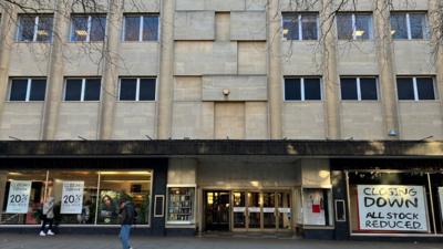 Cavendish House in Cheltenham with closing down signs in window