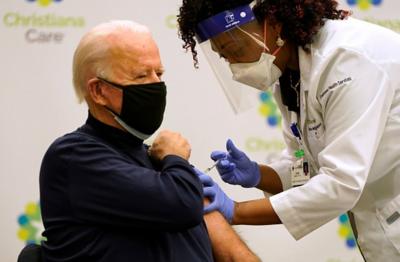 A nurse gives President-elect Joe Biden a Covid-19 vaccine