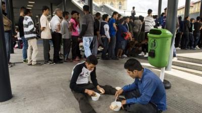 Migrants line up for a food distribution in Keleti railway station in Budapest