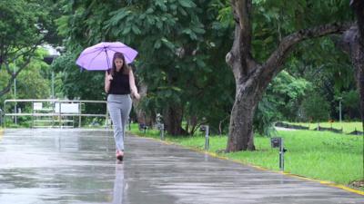 A woman walking on a footpath