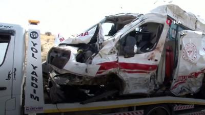 A crushed up ambulance being towed after the crash