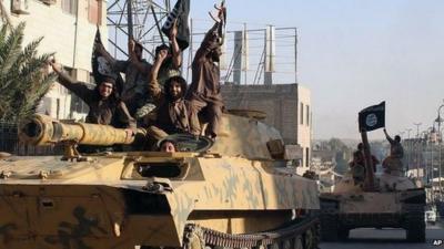 Islamic State fighters drive armoured vehicles through Raqqa, Syria (30 June 2014)