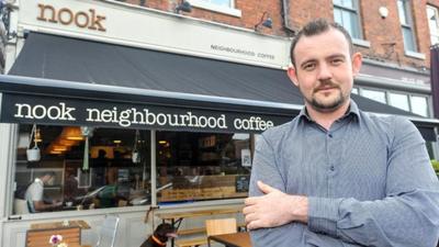 Arlo outside his cafe