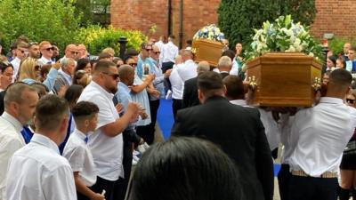 Coffins being carried