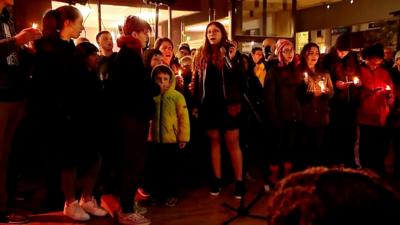 People sing at a vigil