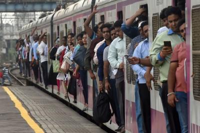 Commuters at a train station in Mumbai