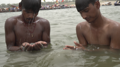 Meet the men who fish for coins for a living in one of India's largest rivers