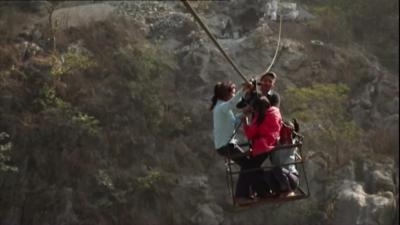 Nepalese children on cable crossing