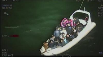 Smugglers and migrants on inflatable boat
