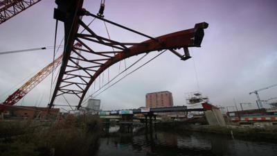 Bridge being lifted into place by crane