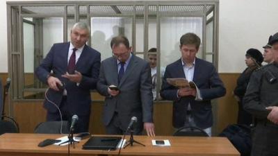 Nadiya Savchenko in court with her lawyers in front of her