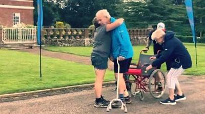 Woman and step-dad hugging