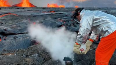 Geologist pouring water on lava sample