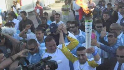 Ibrahim al-Hussein carries Olympic torch