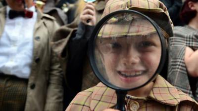 Sherlock Holmes enthusiasts with magnifying glass