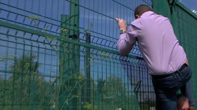 MEP Mike Hookem climbs the fence to prove how easy it is to scale