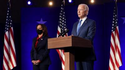 Joe Biden and Kamala Harris standing on stage