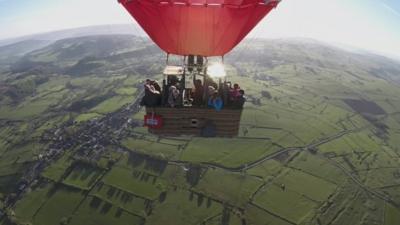 Hot air balloon above countryside