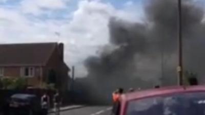 Smoke billowing over crash scene