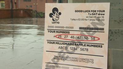 Giant lottery ticket on display in Worcester showing winning numbers