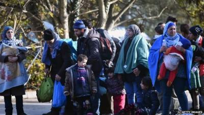 People leave Brezice refugee camp in Slovenia to board buses as they continue they journey north towards Austria