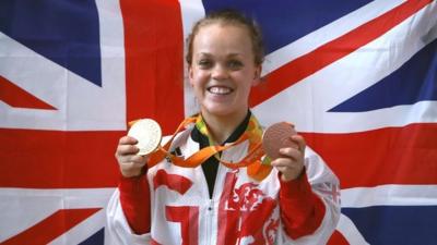 Ellie Simmonds holding her Paralympic medals