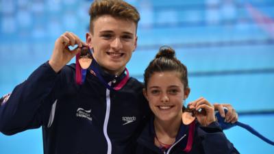 Georgia Ward and Matthew Lee pose with their bronze medals