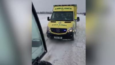 Ambulance being towed on snowy Norfolk road