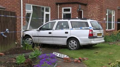 Car embedded in front of house, Trimley St Mary