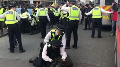 Police medic appears to punch protester