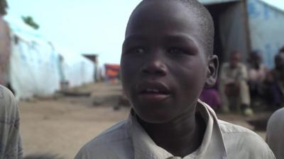 Ibrahim stands in the tented camp in Gwoza