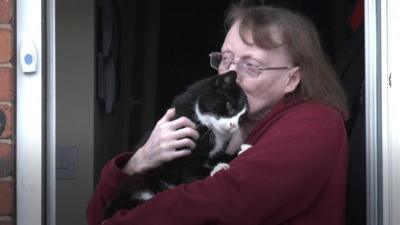 Sharron Scripts hugging a cat