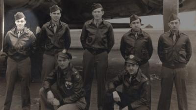 Len Nitti stands with his crew in front of a B17 Flying Fortress.