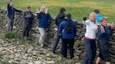 The festival draws volunteers from around the world and offers dyke building, workshops, music and a ceilidh.