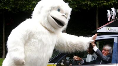 Bernie Ecclestone high-fives a yeti