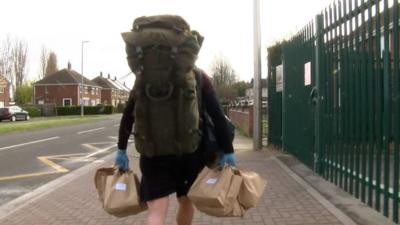 Zane Powles carrying school lunches