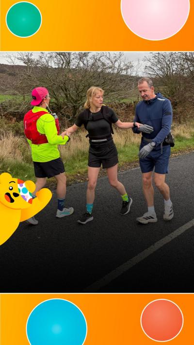 Sara Cox and two trainers walk backwards up hill.