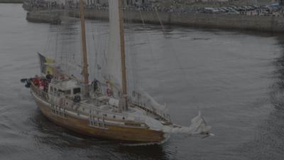 brown and white tall ship sails from Aberdeen harbour