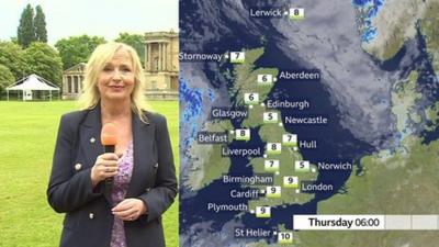 Carol Kirkwood in Buckingham Palace gardens standing by a weather map of the UK