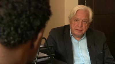 John Simpson speaking to a migrant trafficker