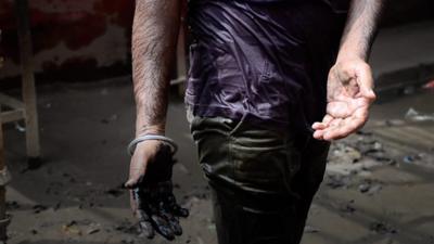 Indian man's hands post sewer unblocking